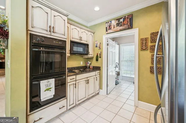 a bedroom with a bed ceiling fan and a wooden floor