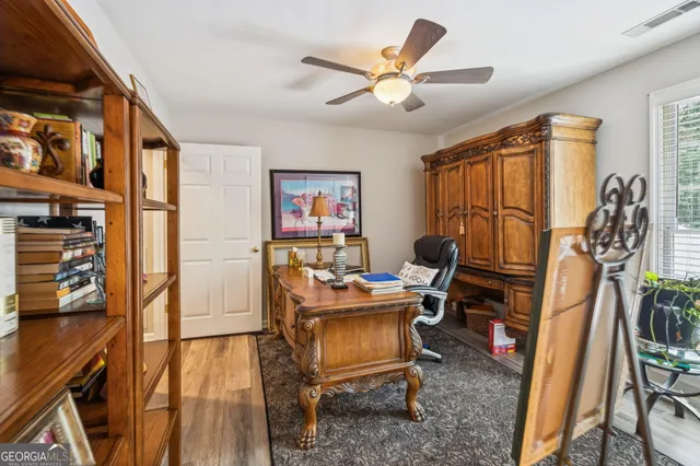 a view of a patio with couches table and chairs under an umbrella