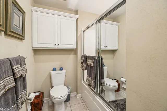 a view of a white house with a yard and large tree