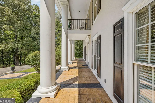 a living room with furniture a fireplace and a floor to ceiling window
