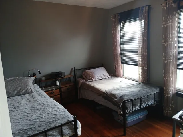 a bedroom with furniture and a chair