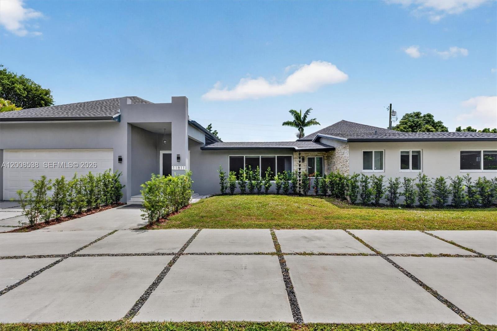 11811 Southwest 82nd Road Miami, FL 33156 - Photo 1 of 63 a front view of a house with a yard and potted plants