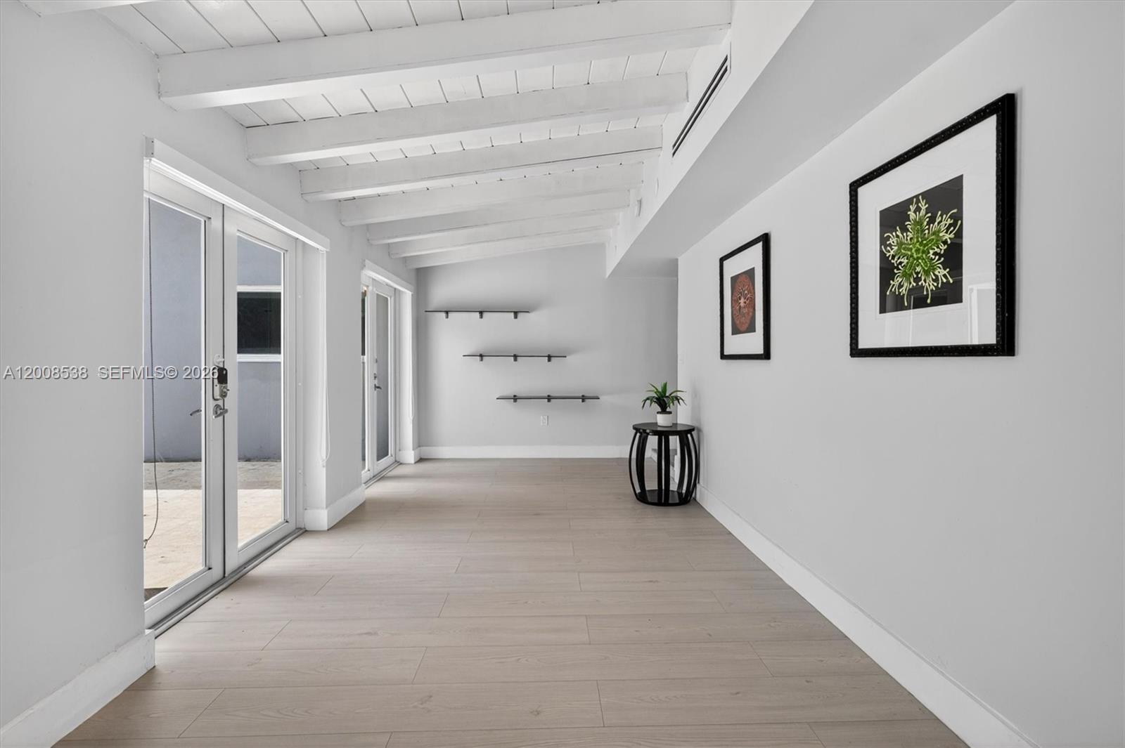 11811 Southwest 82nd Road Miami, FL 33156 - Photo 12 of 63 a view of a livingroom with wooden floor and a ceiling fan