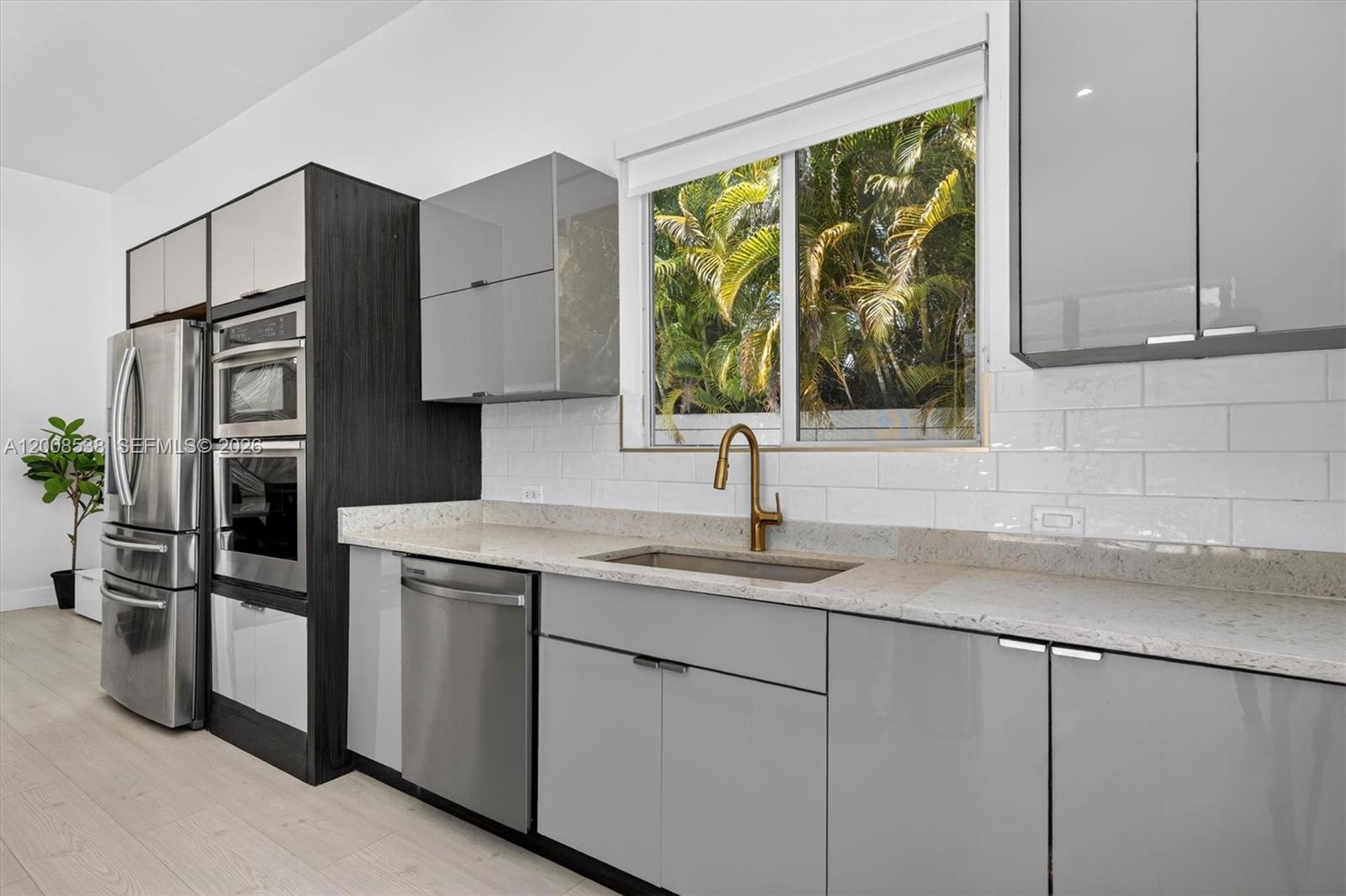 11811 Southwest 82nd Road Miami, FL 33156 - Photo 15 of 63 a kitchen with stainless steel appliances granite countertop a sink and a cabinets