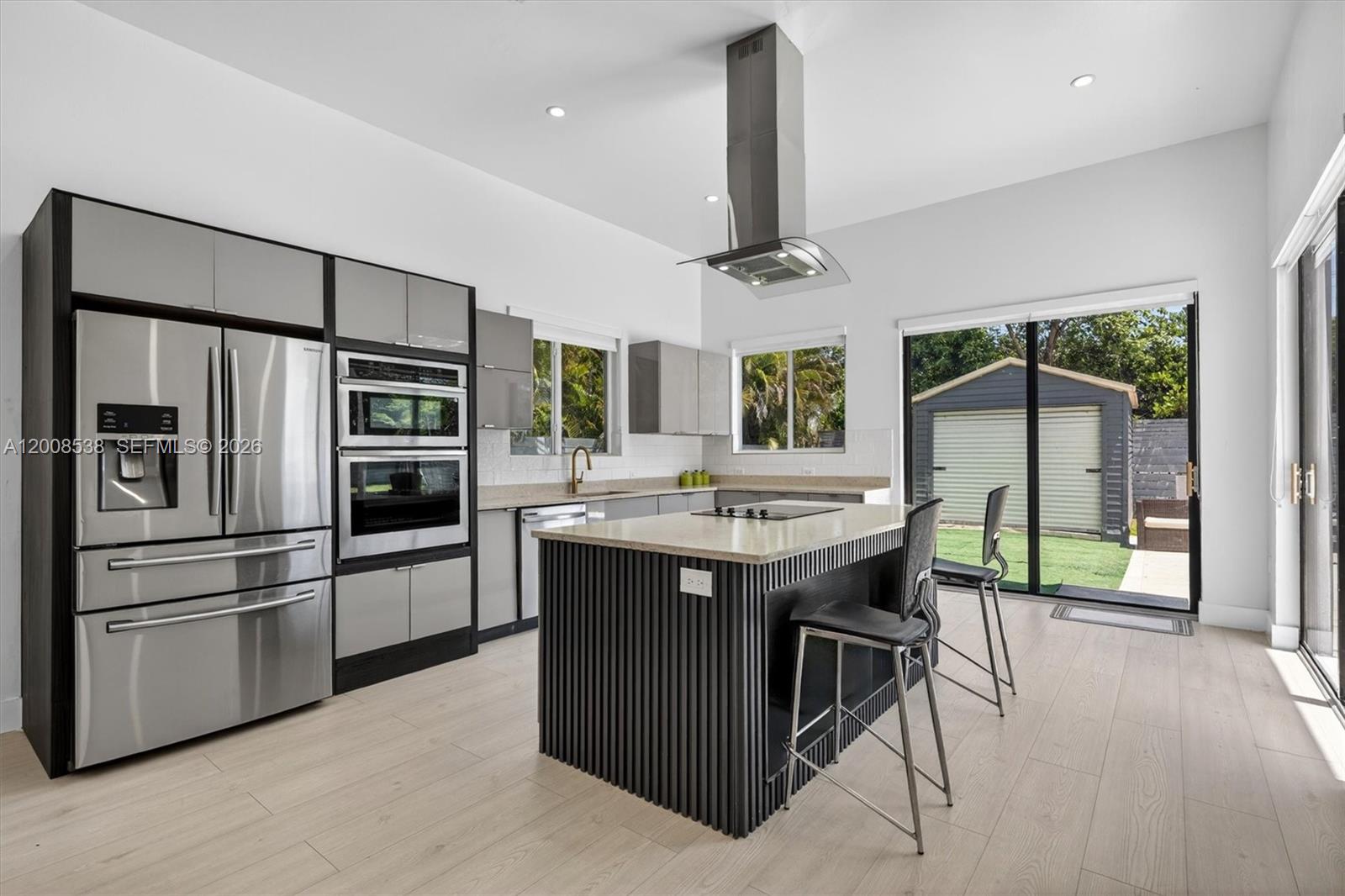 11811 Southwest 82nd Road Miami, FL 33156 - Photo 17 of 63 a kitchen with a stove a refrigerator and a sink