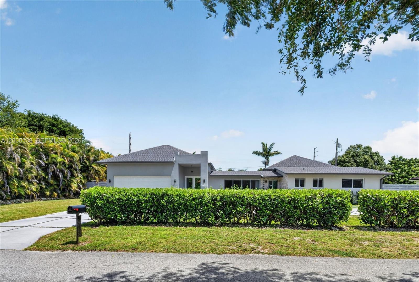11811 Southwest 82nd Road Miami, FL 33156 - Photo 2 of 63 a front view of a house with a yard
