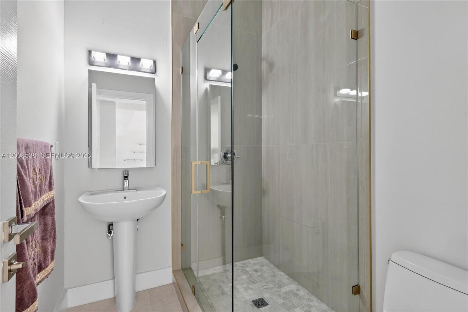 11811 Southwest 82nd Road Miami, FL 33156 - Photo 22 of 63 a bathroom with a sink a mirror and shower