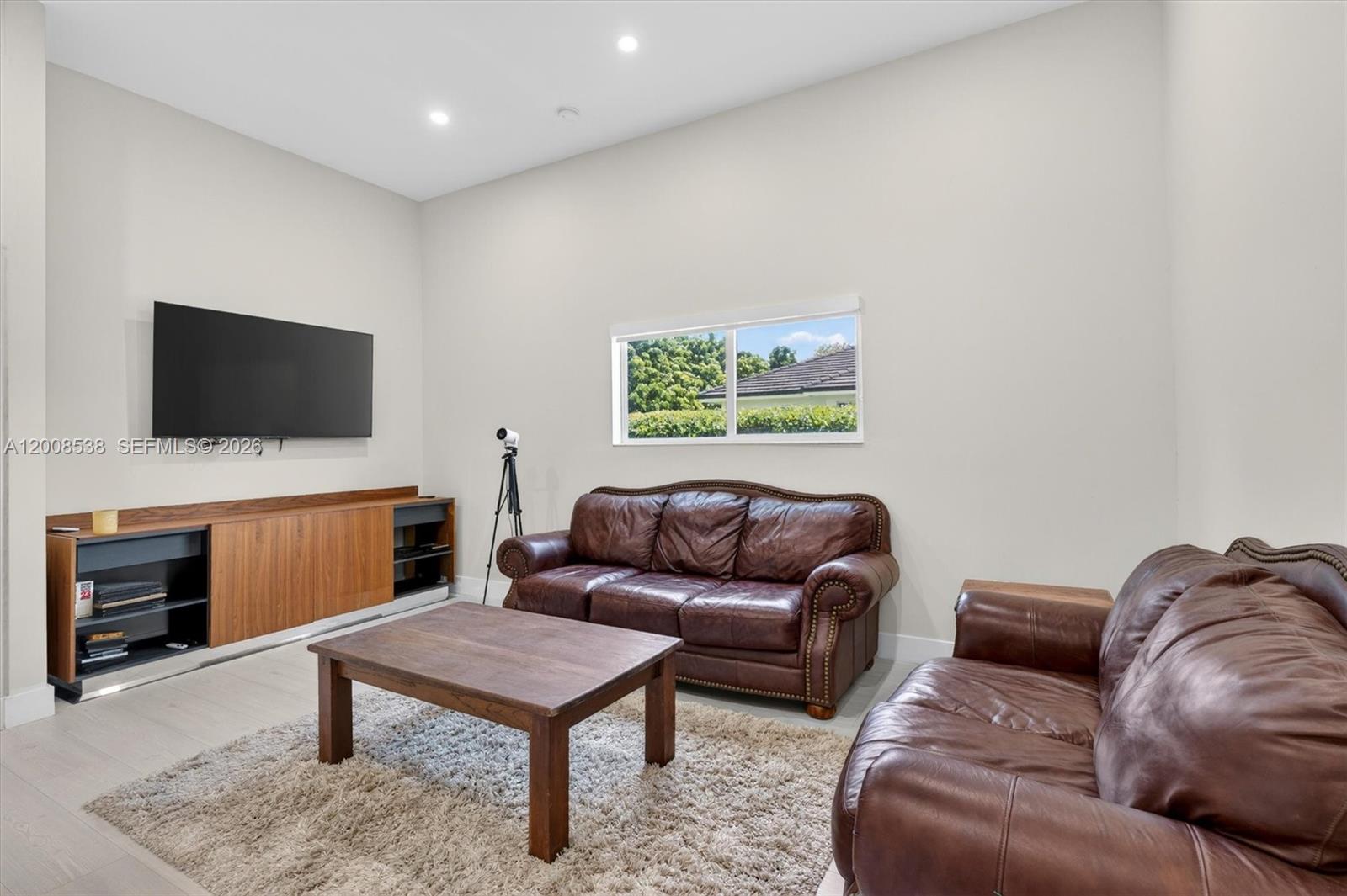 11811 Southwest 82nd Road Miami, FL 33156 - Photo 24 of 63 a living room with furniture and a flat screen tv