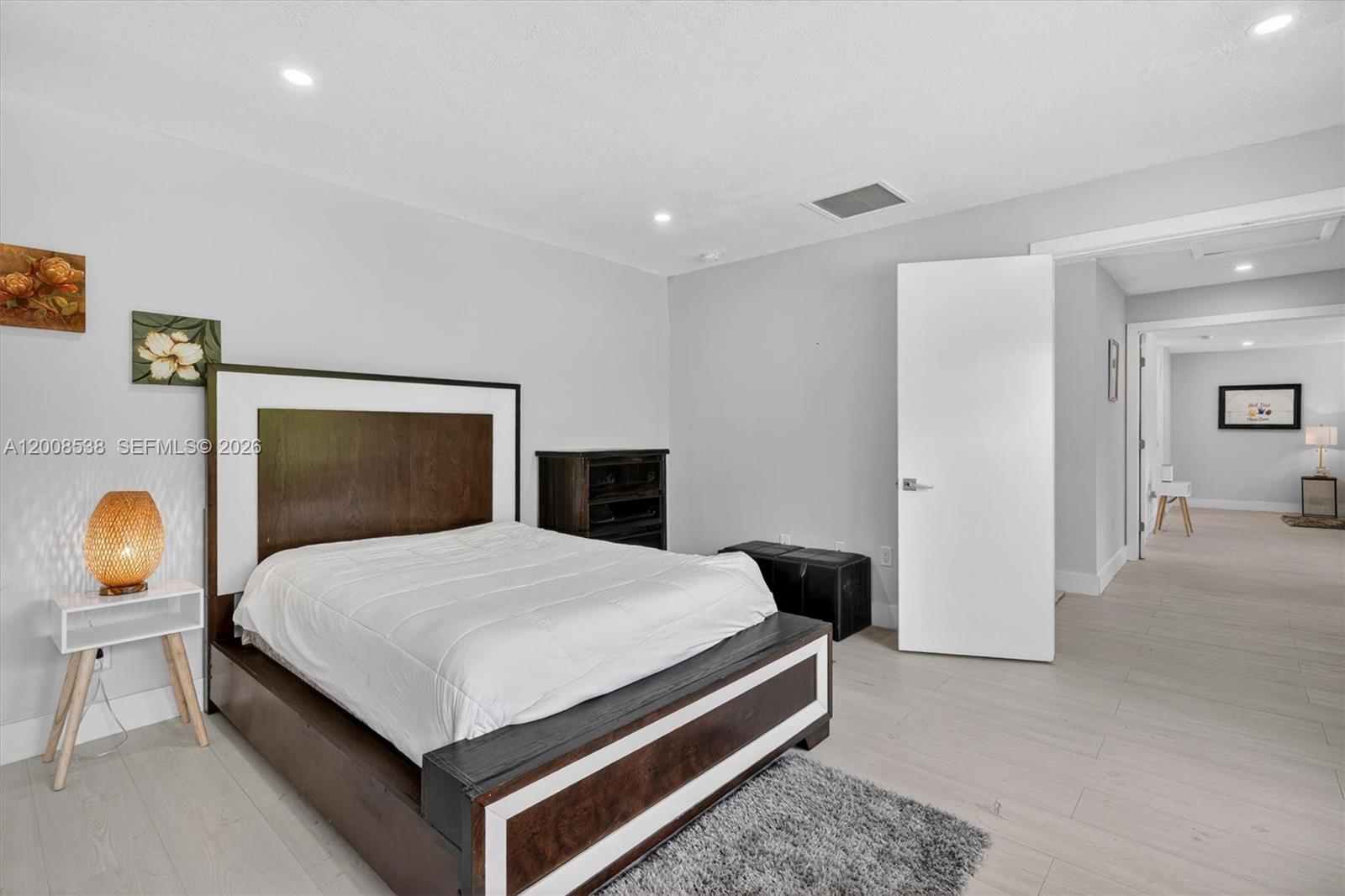11811 Southwest 82nd Road Miami, FL 33156 - Photo 28 of 63 a bedroom with a bed and lamp