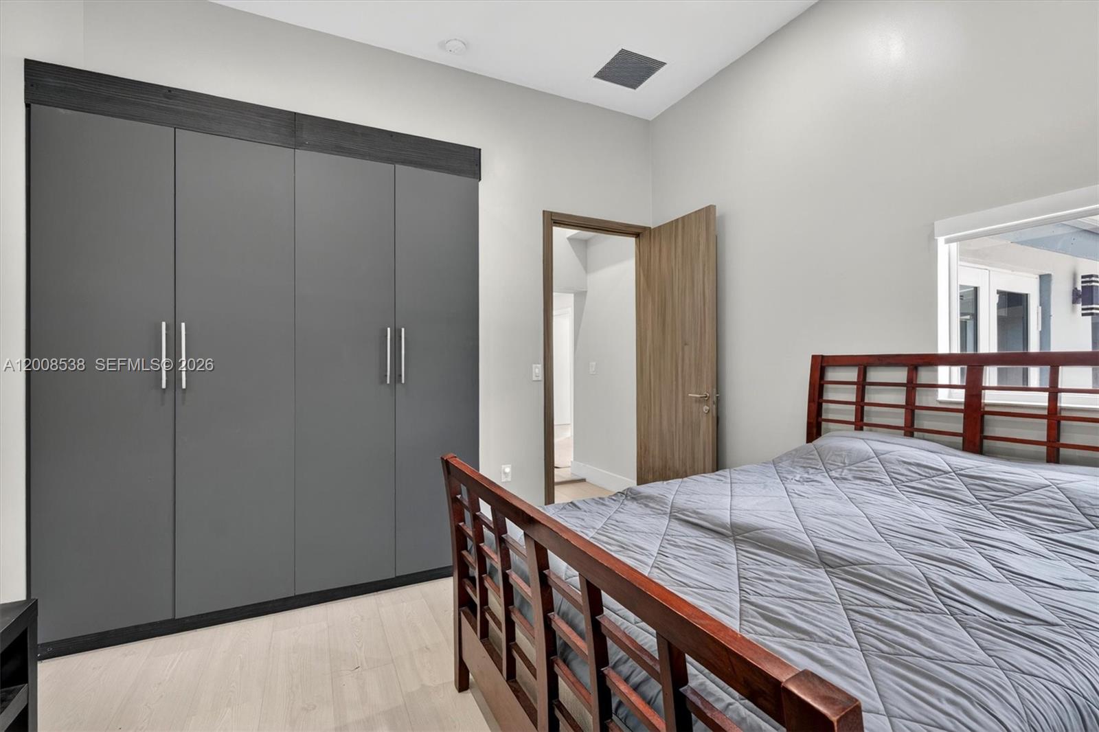 11811 Southwest 82nd Road Miami, FL 33156 - Photo 32 of 63 a bedroom with a bed and a table