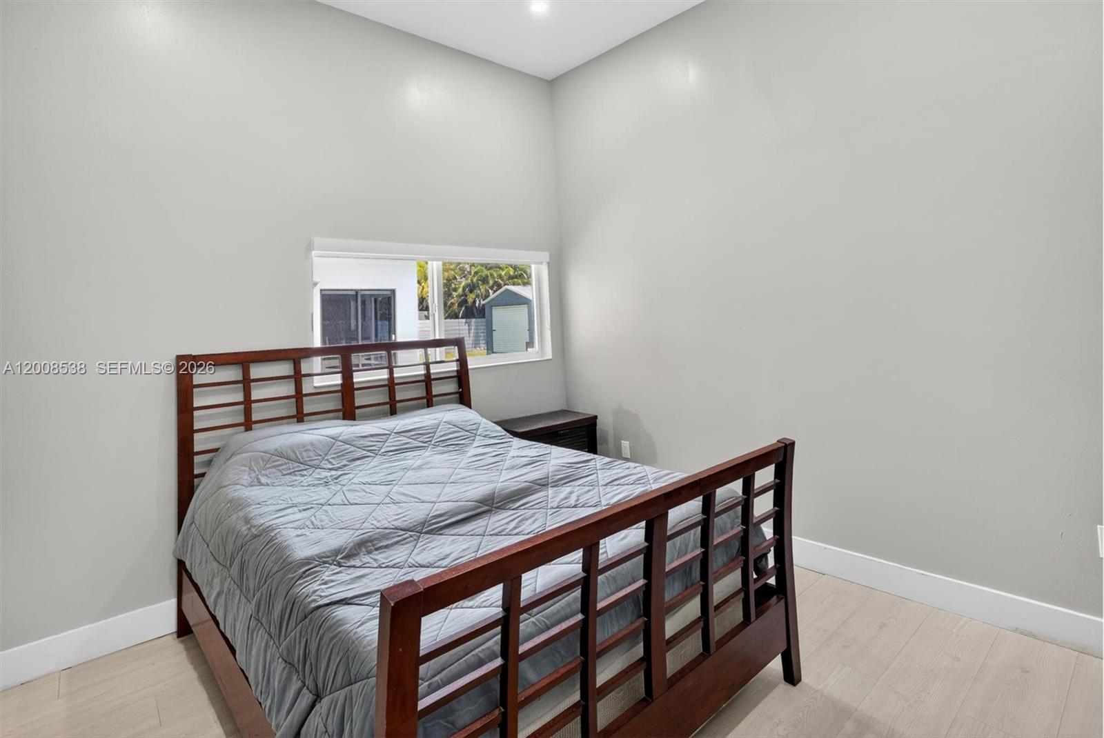 11811 Southwest 82nd Road Miami, FL 33156 - Photo 33 of 63 a bedroom with a bed and a window