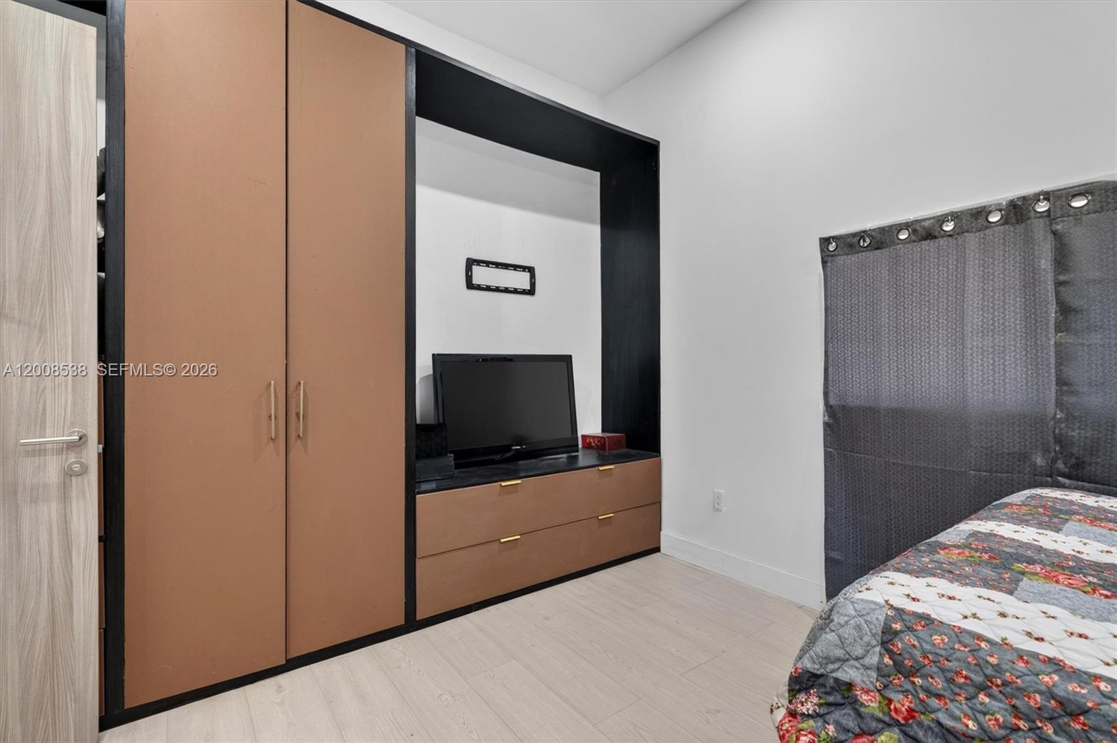11811 Southwest 82nd Road Miami, FL 33156 - Photo 35 of 63 a bedroom with a bed and flat screen tv