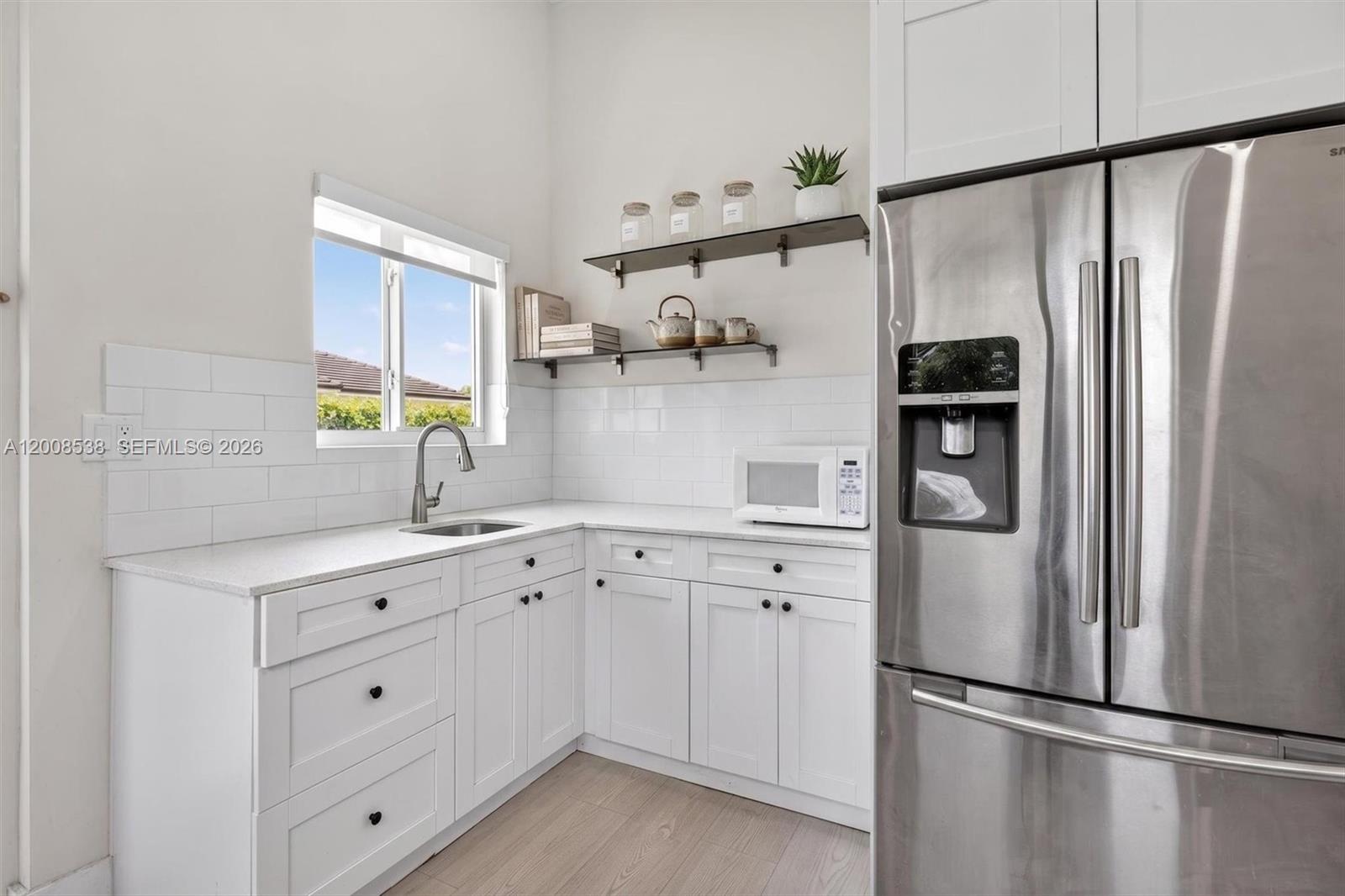 11811 Southwest 82nd Road Miami, FL 33156 - Photo 37 of 63 a kitchen with white cabinets and refrigerator