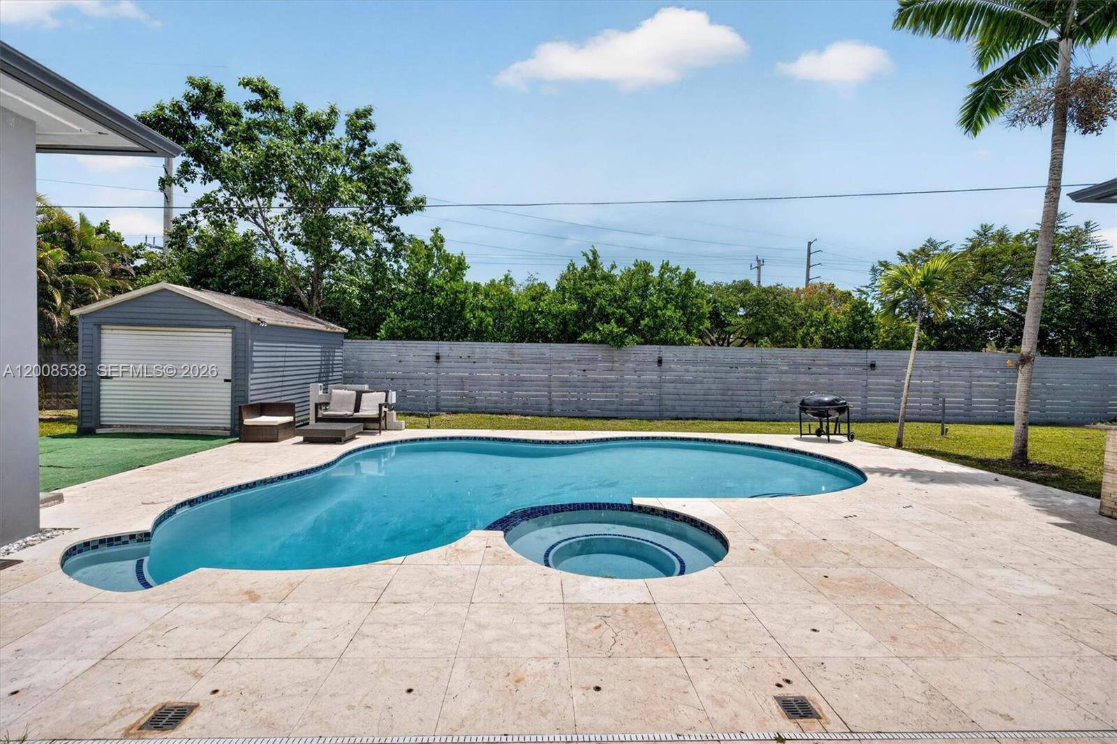 11811 Southwest 82nd Road Miami, FL 33156 - Photo 45 of 63 a view of a swimming pool with a patio
