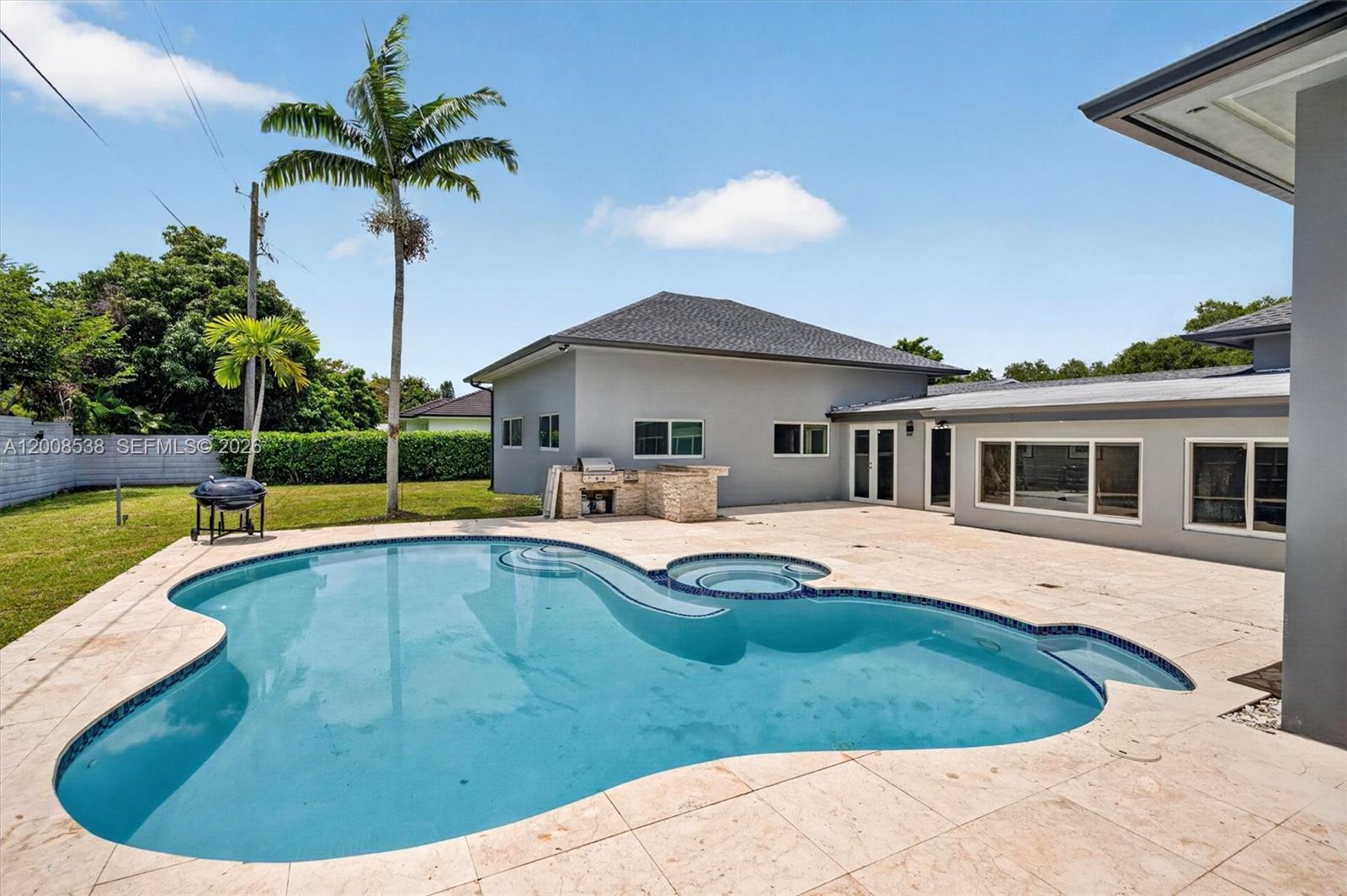 11811 Southwest 82nd Road Miami, FL 33156 - Photo 51 of 63 a view of a house with swimming pool and porch