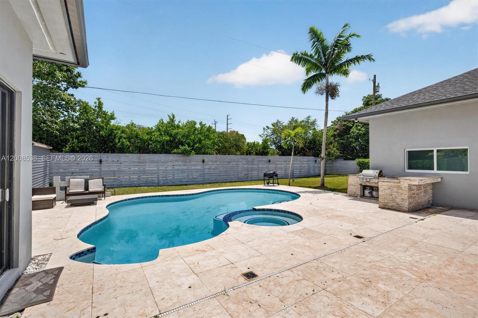 11811 Southwest 82nd Road Miami, FL 33156 - Photo 52 of 63 a swimming pool with wooden fence