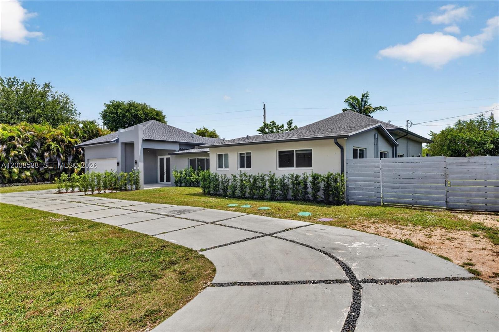 11811 Southwest 82nd Road Miami, FL 33156 - Photo 6 of 63 a front view of a house with a yard and garage