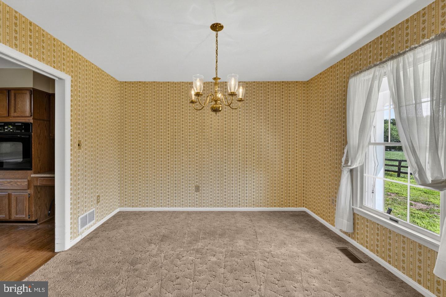 40297 Braddock Road Aldie, VA 20105 - Photo 14 of 34 a view of a room with window wooden floor and chandelier