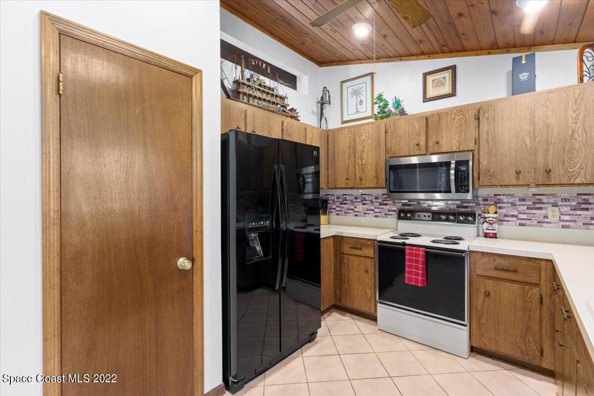 224 Rheine Road Northwest Palm Bay, FL 32907 - Photo 11 of 32 a kitchen with stainless steel appliances granite countertop a refrigerator and a stove