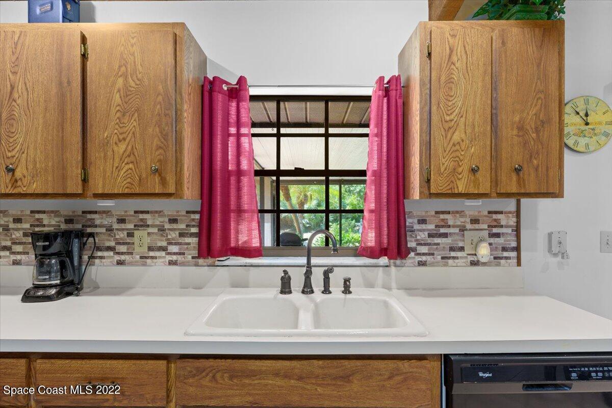 224 Rheine Road Northwest Palm Bay, FL 32907 - Photo 12 of 32 a kitchen with a sink and a window