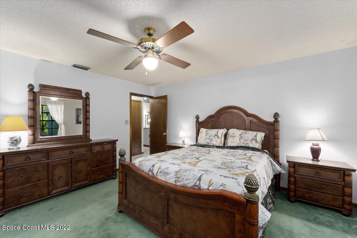 224 Rheine Road Northwest Palm Bay, FL 32907 - Photo 15 of 32 a bedroom with a bed and a large dresser