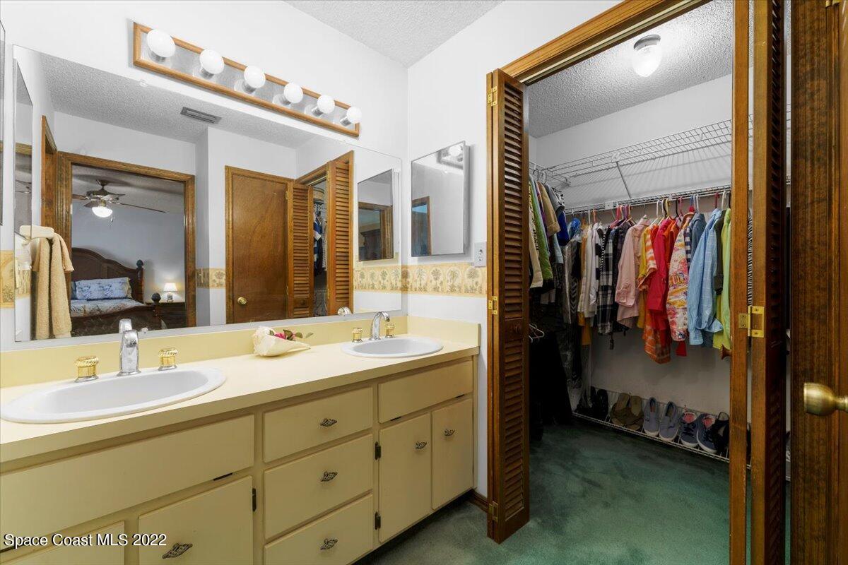 224 Rheine Road Northwest Palm Bay, FL 32907 - Photo 17 of 32 a bathroom with a double vanity sink and mirror
