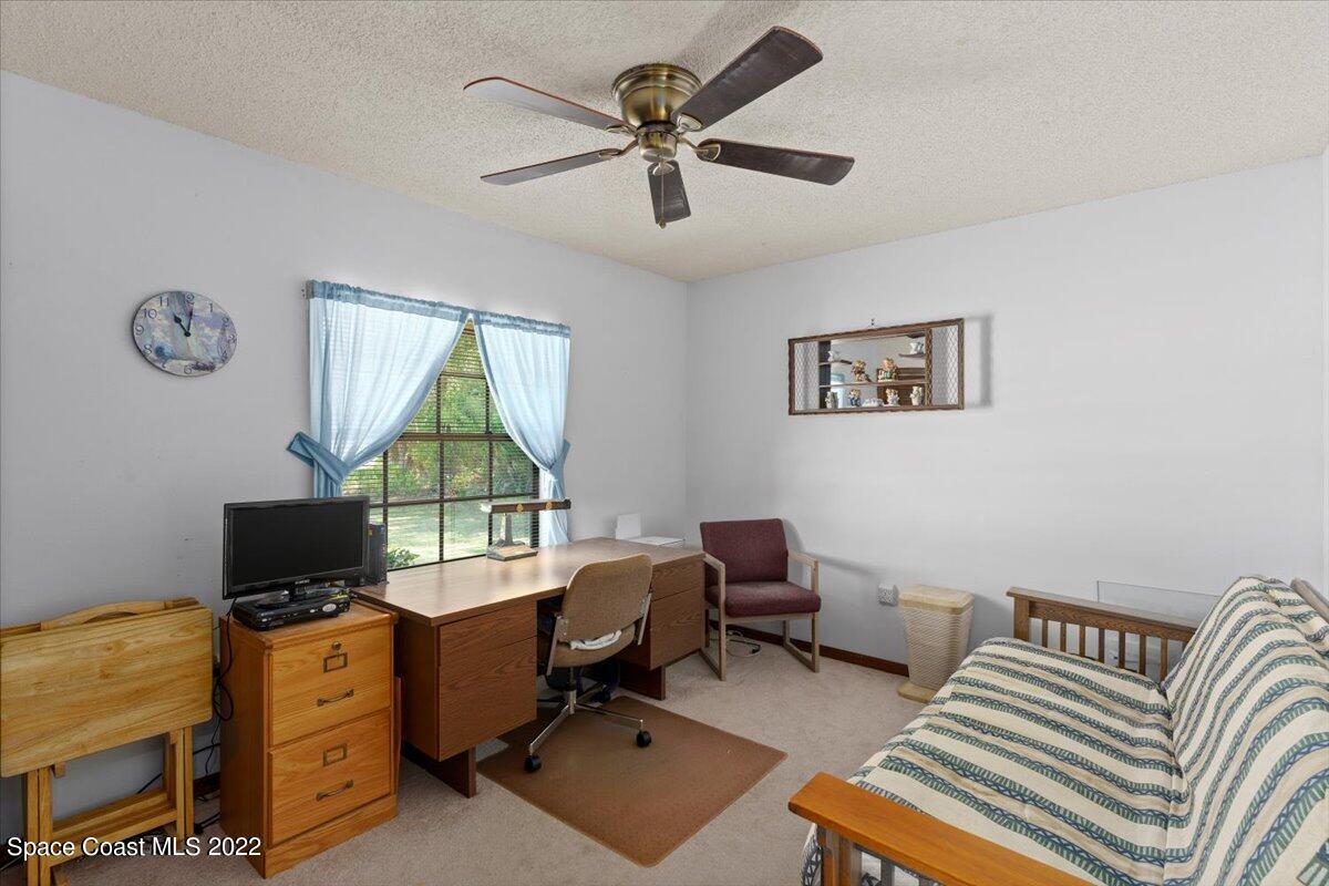 224 Rheine Road Northwest Palm Bay, FL 32907 - Photo 19 of 32 a bedroom with a workspace