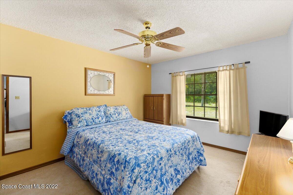 224 Rheine Road Northwest Palm Bay, FL 32907 - Photo 22 of 32 a bedroom with a bed and a window