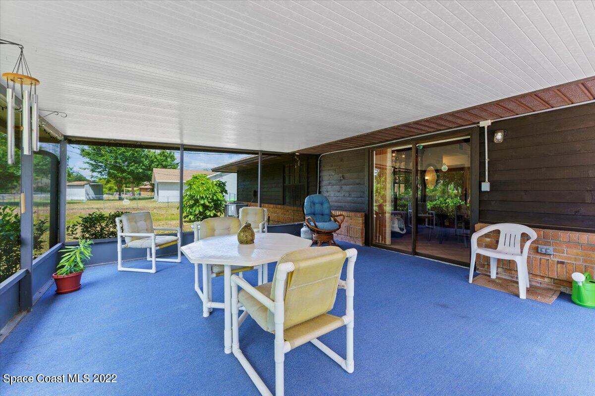 224 Rheine Road Northwest Palm Bay, FL 32907 - Photo 25 of 32 a view of a dining room with furniture window and outside view