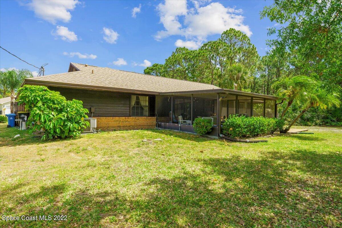 224 Rheine Road Northwest Palm Bay, FL 32907 - Photo 27 of 32 a front view of a house with garden