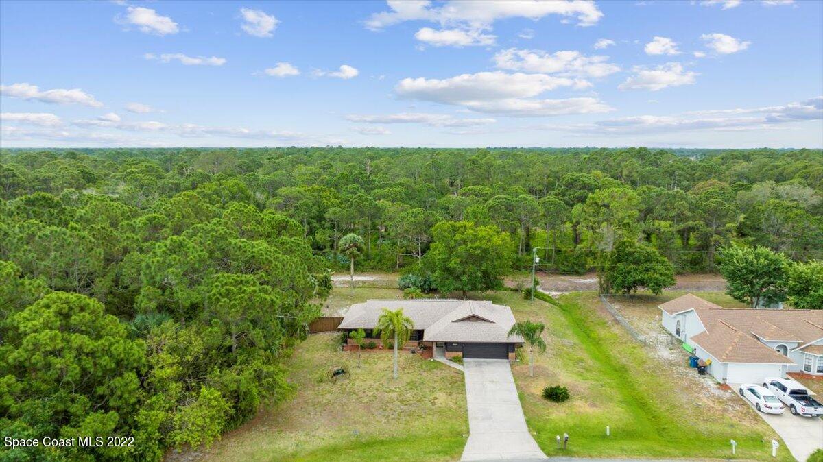 224 Rheine Road Northwest Palm Bay, FL 32907 - Photo 32 of 32 a view of yard with swimming pool and outdoor seating