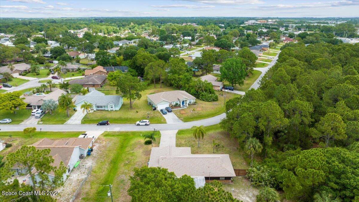 224 Rheine Road Northwest Palm Bay, FL 32907 - Photo 4 of 32 an aerial view of residential houses with outdoor space and trees