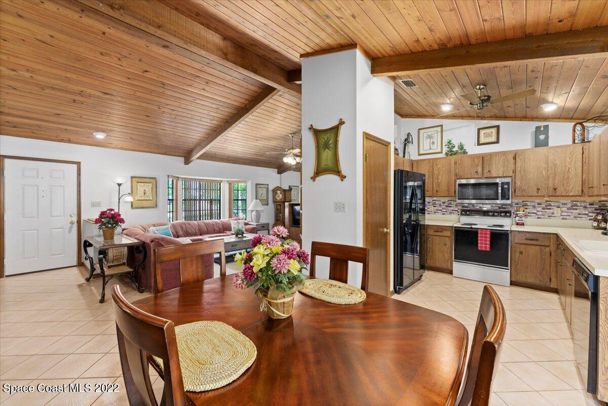 224 Rheine Road Northwest Palm Bay, FL 32907 - Photo 7 of 32 a living room with stainless steel appliances kitchen island granite countertop furniture and a kitchen view