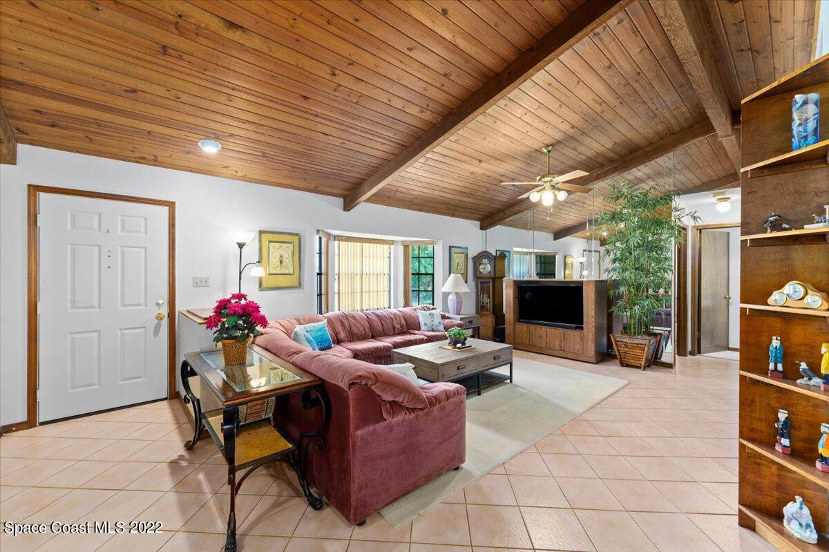 224 Rheine Road Northwest Palm Bay, FL 32907 - Photo 8 of 32 a living room with furniture and a flat screen tv