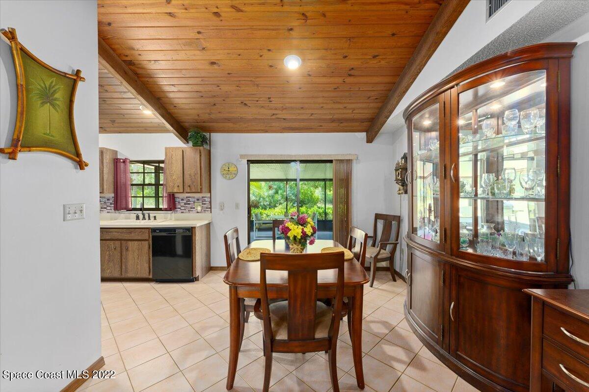 224 Rheine Road Northwest Palm Bay, FL 32907 - Photo 10 of 32 a view of a dining room with furniture window and outside view