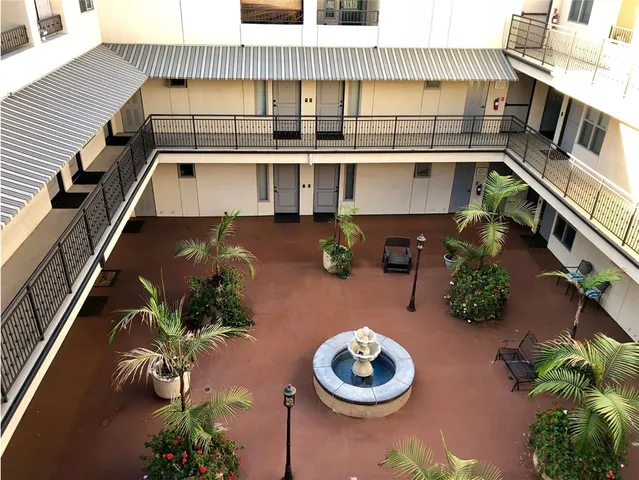 a backyard of a house with table and chairs