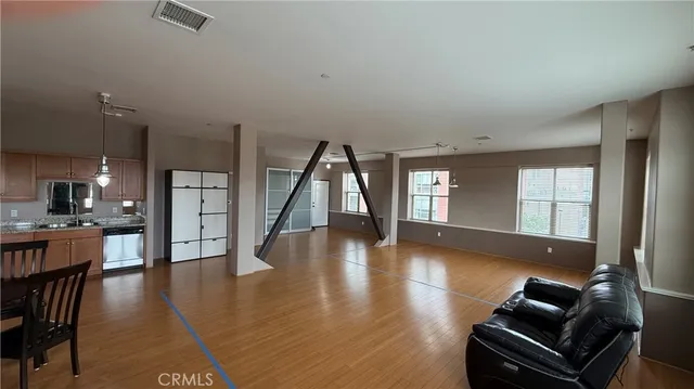 a living room with furniture wooden floor and a large window