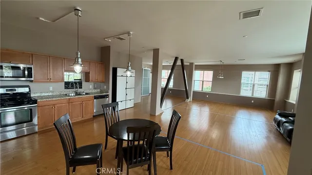 a dining room with furniture and wooden floor