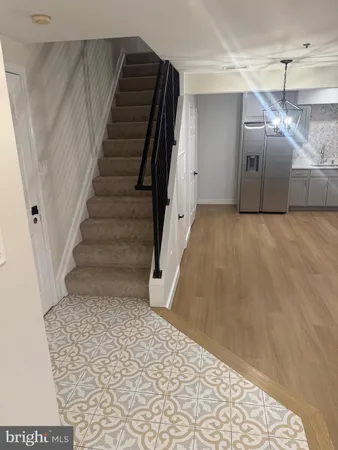 a big room with wooden floor and a fireplace