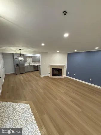 a large kitchen with a large stainless steel refrigerator and a sink