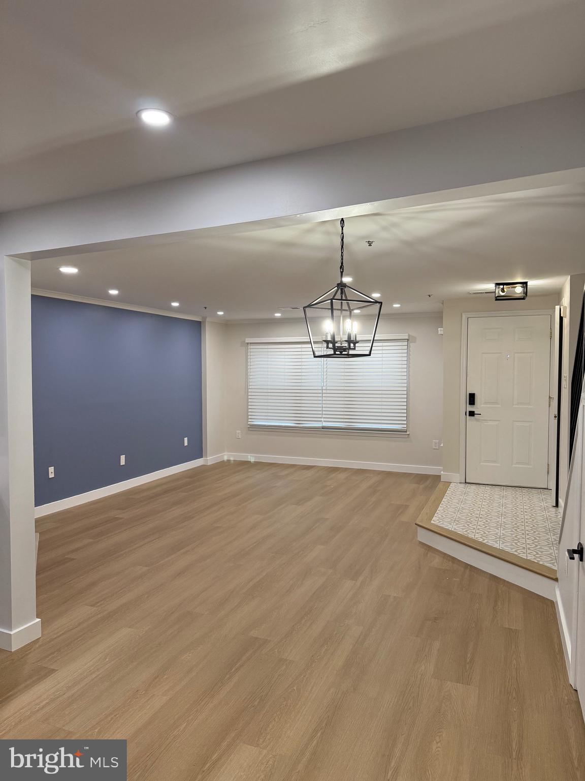 11281 Raging Brook Drive, Unit 307 Bowie, MD 20720 - Photo 5 of 11 a view of an empty room with a chandelier