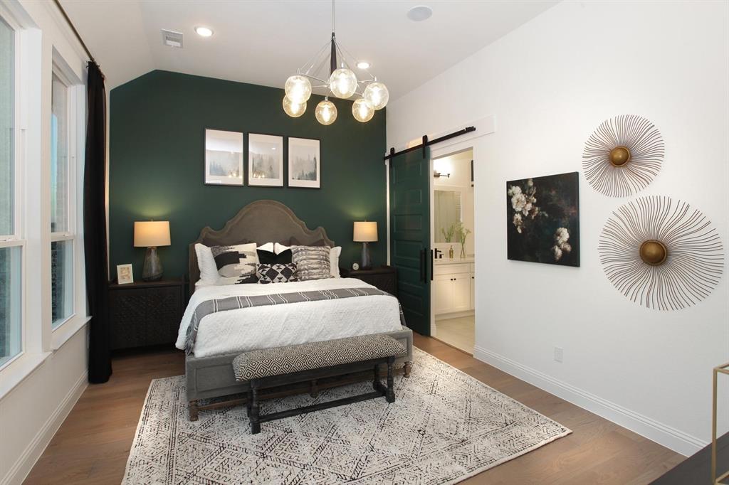 240 South Bee Balm Road McKinney, TX 75071 - Photo 9 of 23 a bedroom with a bed and a chandelier
