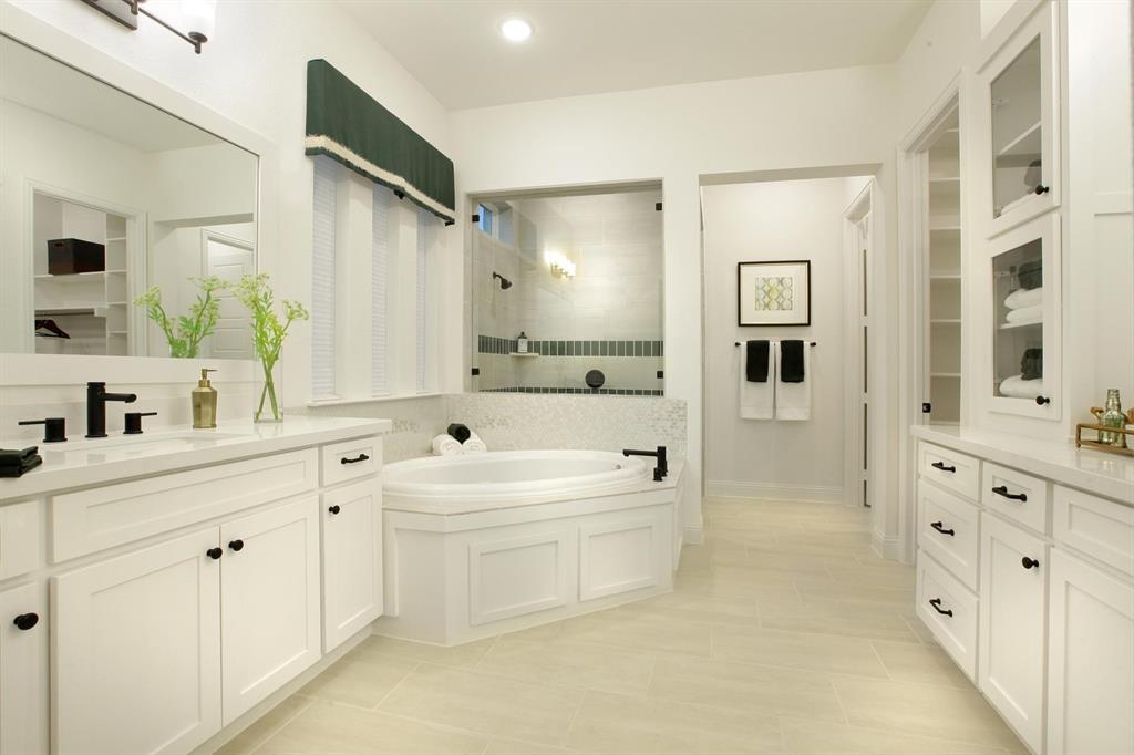 240 South Bee Balm Road McKinney, TX 75071 - Photo 10 of 23 a spacious bathroom with a double vanity sink a mirror and a bathtub