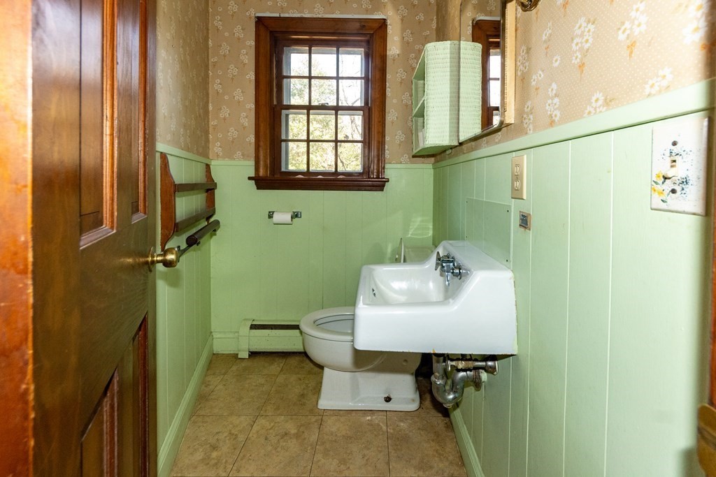 1489 Main Road Westport, MA 02790 - Photo 14 of 24 a bathroom with a sink a toilet and a window