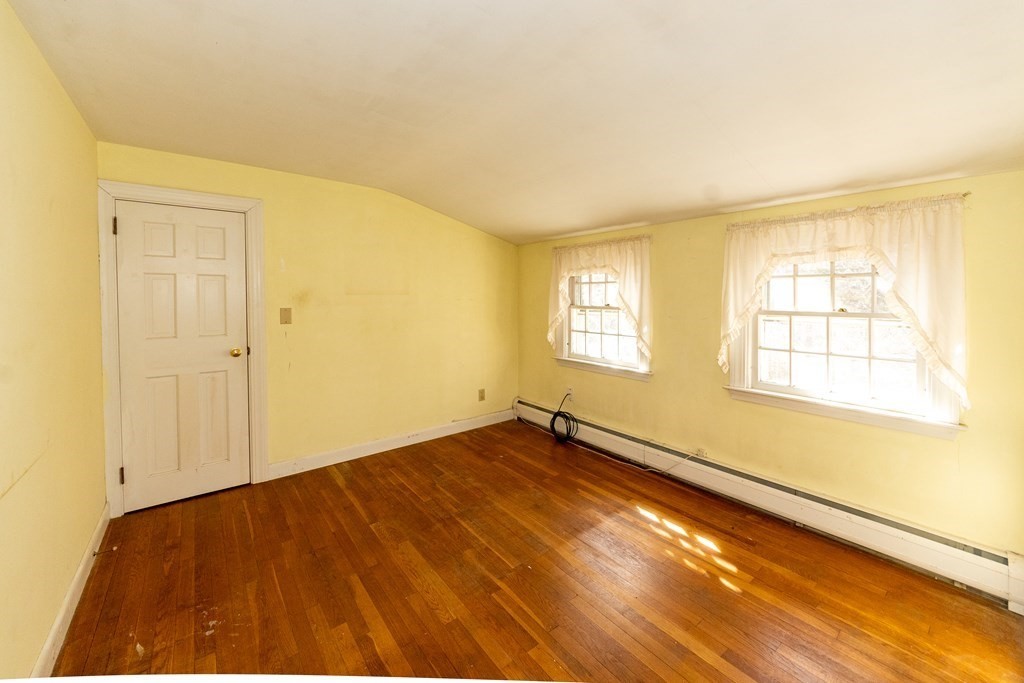 1489 Main Road Westport, MA 02790 - Photo 17 of 24 a view of an empty room with wooden floor and a window