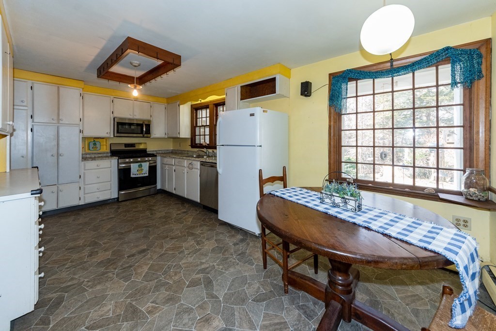 1489 Main Road Westport, MA 02790 - Photo 4 of 24 a kitchen that has a table and chairs in it