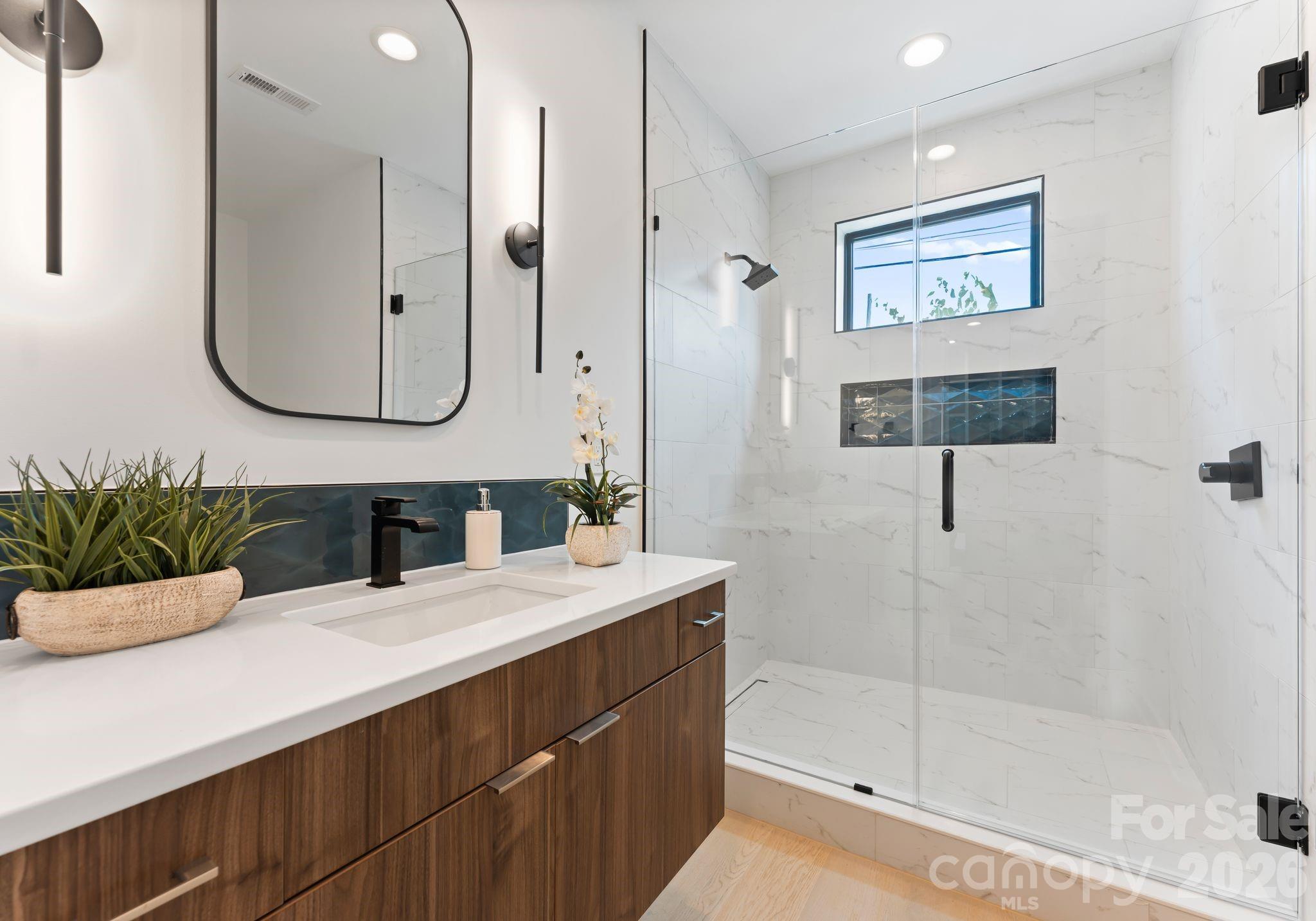 412 State Street Charlotte, NC 28208 - Photo 12 of 31 a bathroom with a sink a mirror and a shower
