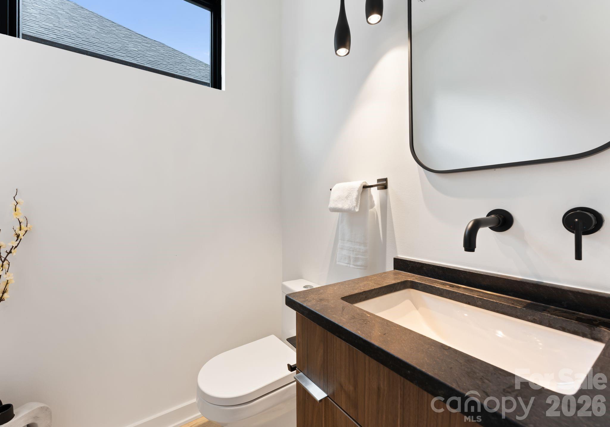 412 State Street Charlotte, NC 28208 - Photo 14 of 31 a bathroom with a sink a toilet and a mirror