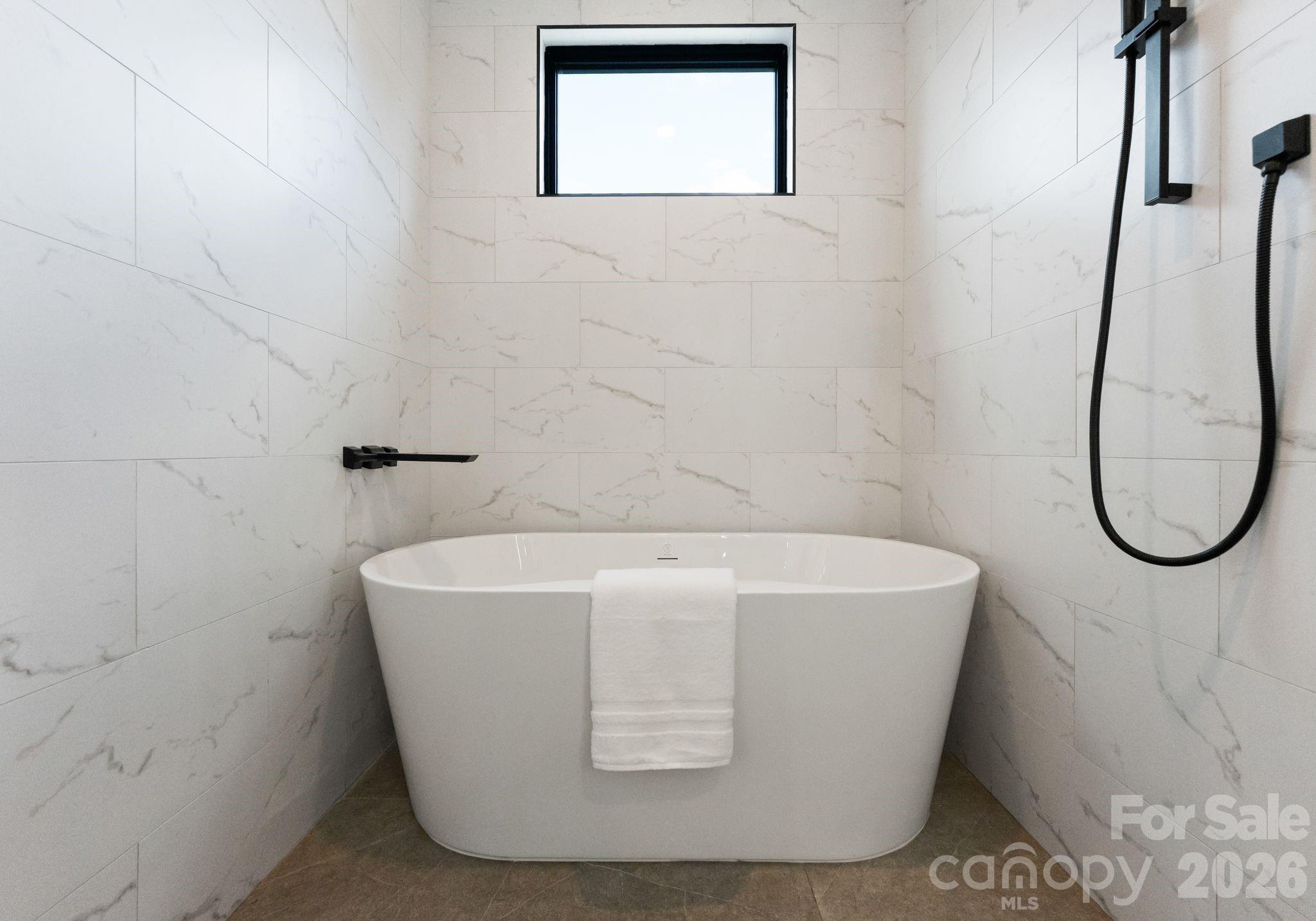 412 State Street Charlotte, NC 28208 - Photo 22 of 31 a white bath tub sitting in a bathroom