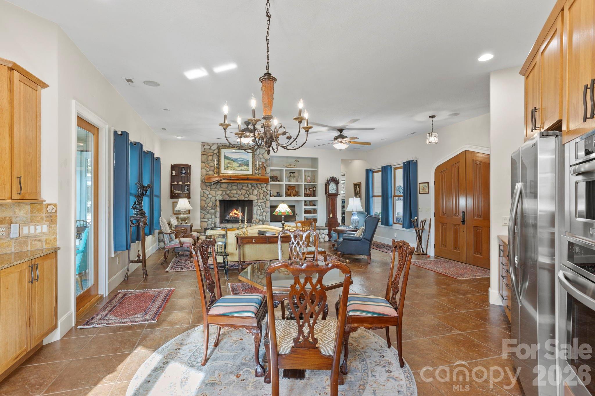 628 Vista Falls Road Mills River, NC 28759 - Photo 17 of 37 a view of a dining room with furniture a chandelier and wooden floor